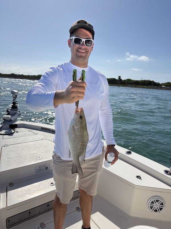 Angler holding a seatrout aboard the boat