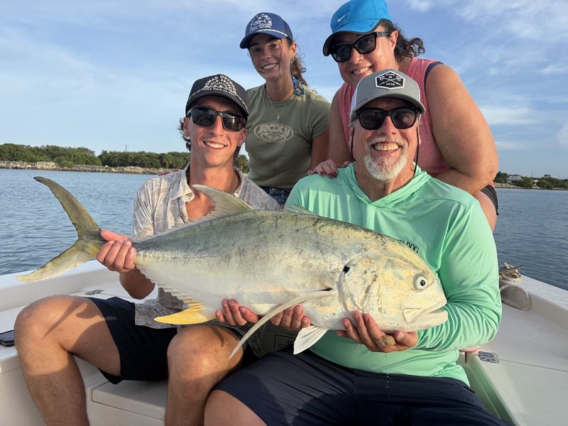 Family group with a jack crevalle on a full day charter