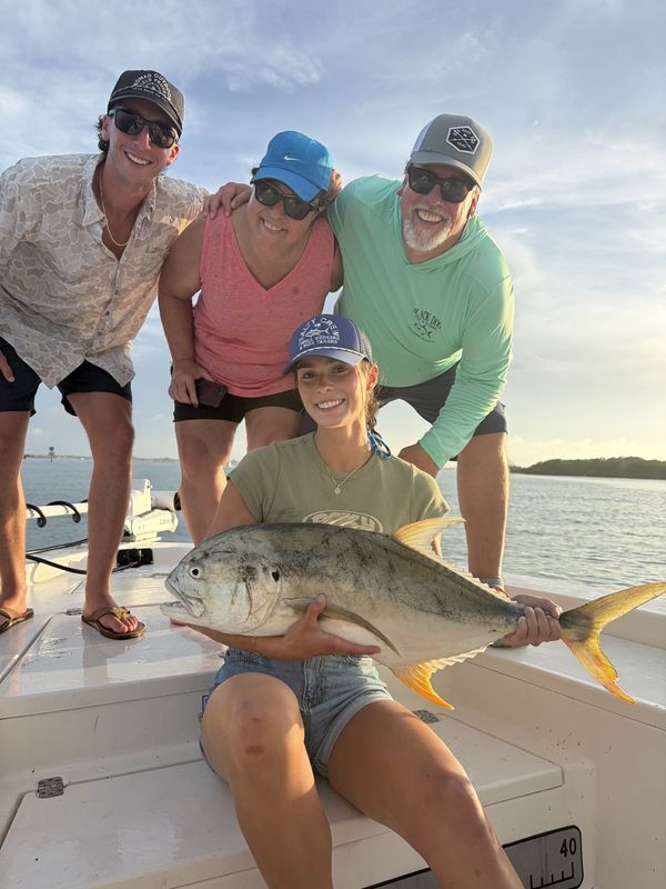 Group of anglers with a big jack crevalle on the lagoon