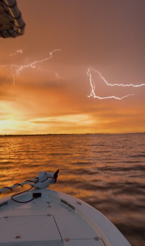 Lightning over the lagoon at dusk, seen from the boat