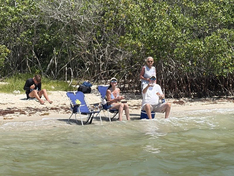 Family relaxing on the sand on a sandbar charter